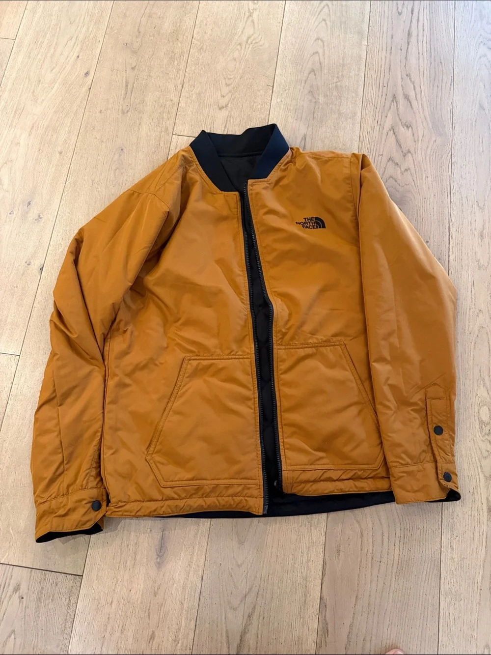 The North Face Men's Quilted Bomber Jacket in Black with Mustard reversible